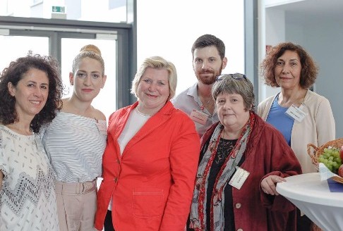 Gruppenfoto von Teilnehmenden beim Jubiläum des NTFN (Netzwerk für traumatisierte Flüchtlinge in Niedersachsen e.V.), sechs Personen lächeln in die Kamera.